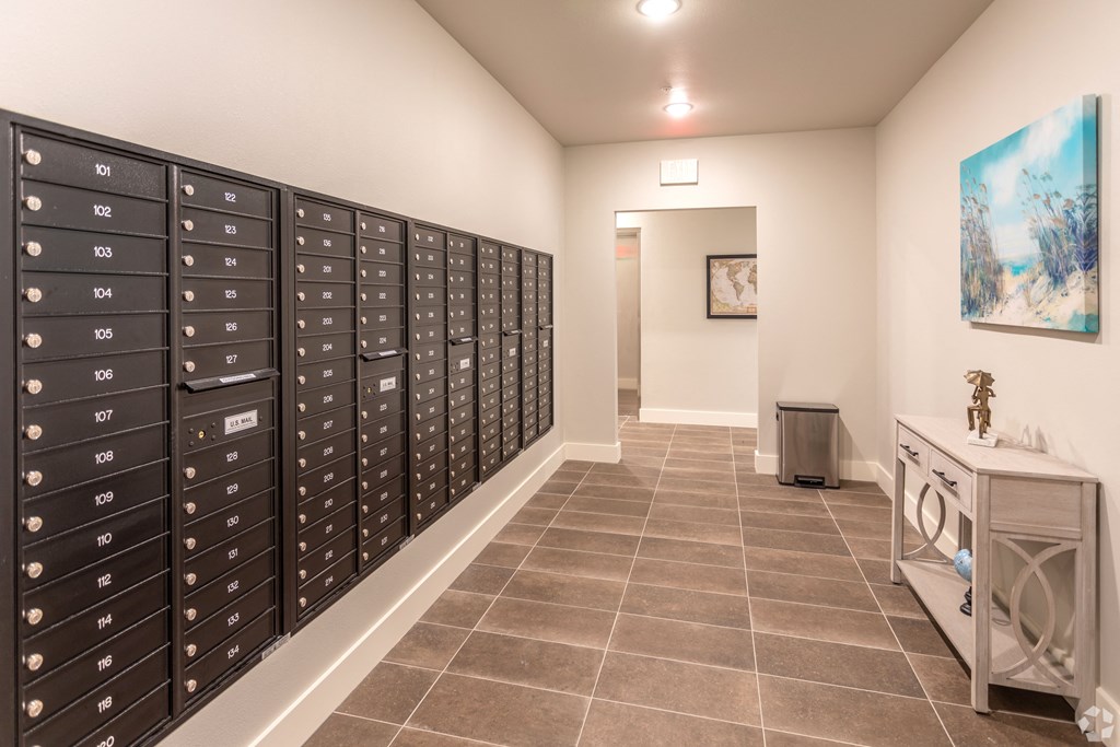 the lockers in the laundry room of a home with a painting on the wall