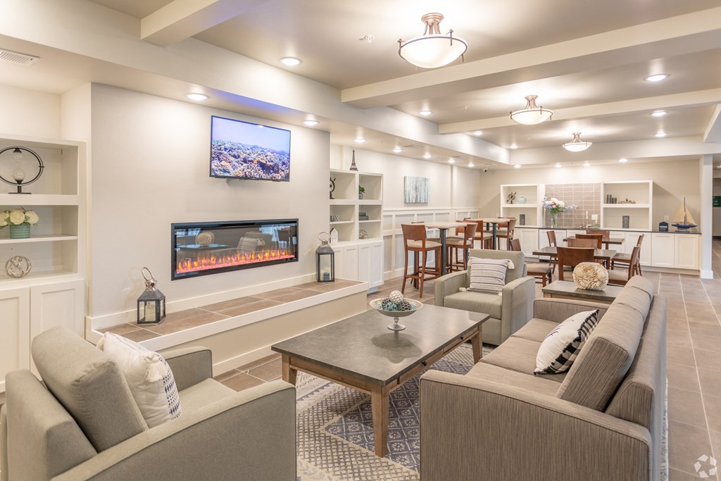 a living room with couches and chairs and a fireplace