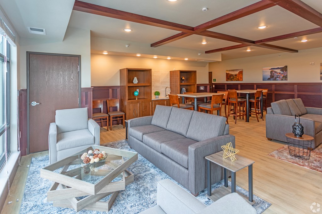 a living room and dining room with couches and chairs and a table