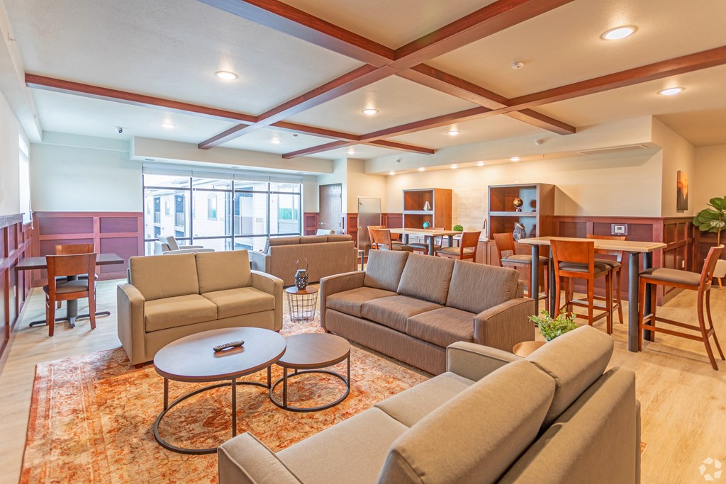 a living room and dining room with couches and chairs and a table