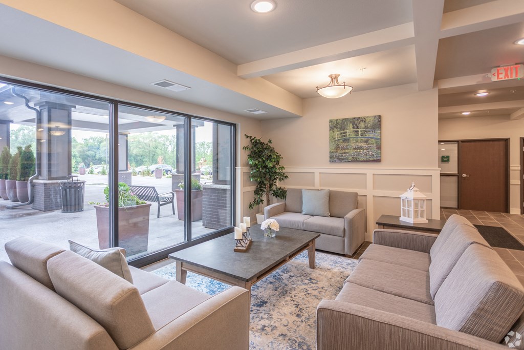 a living room with couches and a coffee table    and a patio