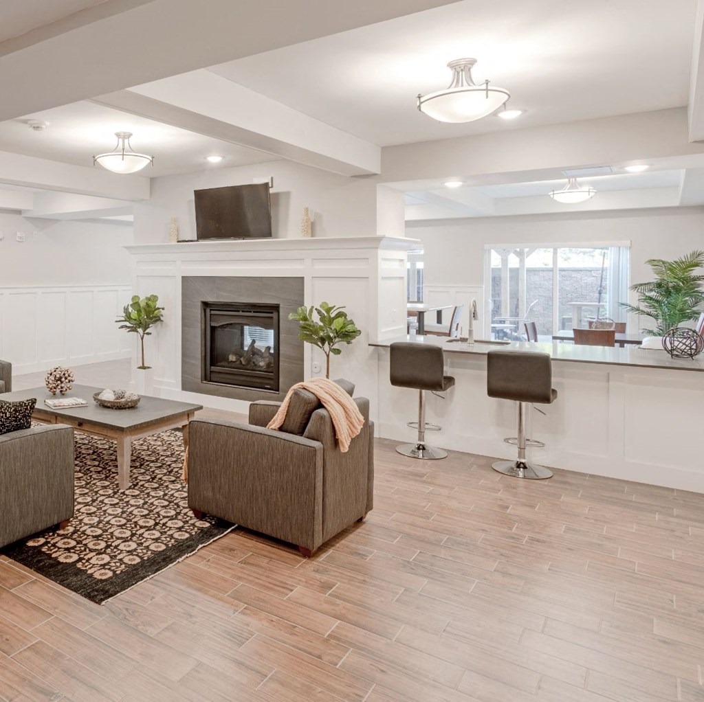 a living room with a fireplace and a table with chairs