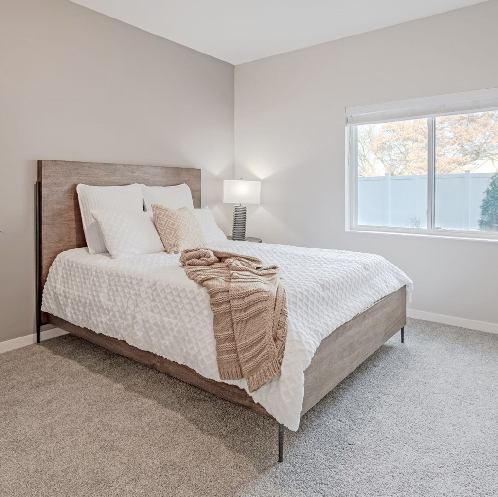 a bedroom with a bed and a window