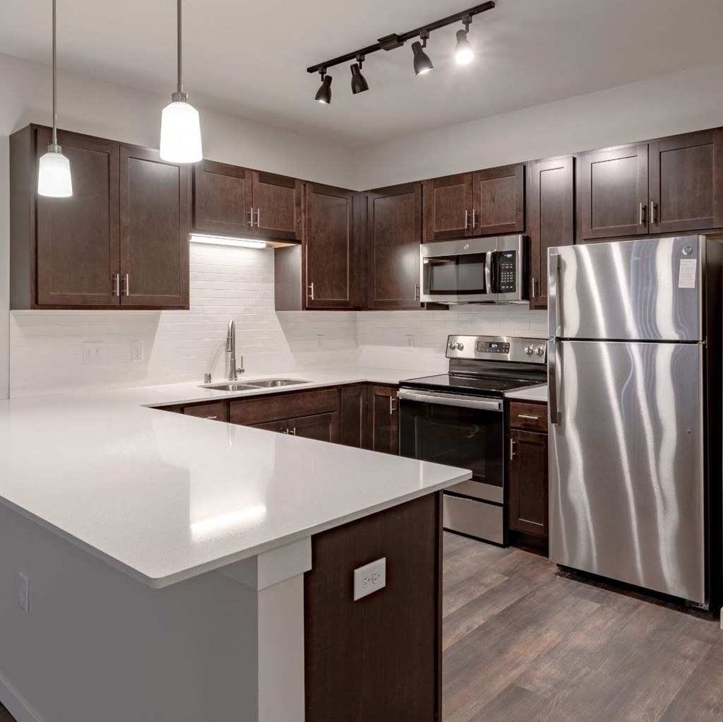 full kitchen with stainless steel appliances at the district flats apartments in lenexa