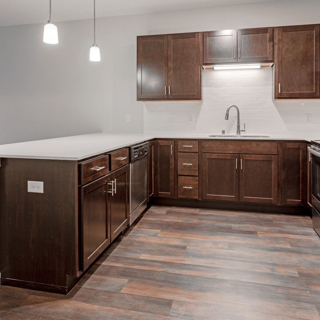 a kitchen with wooden cabinets and a white counter top