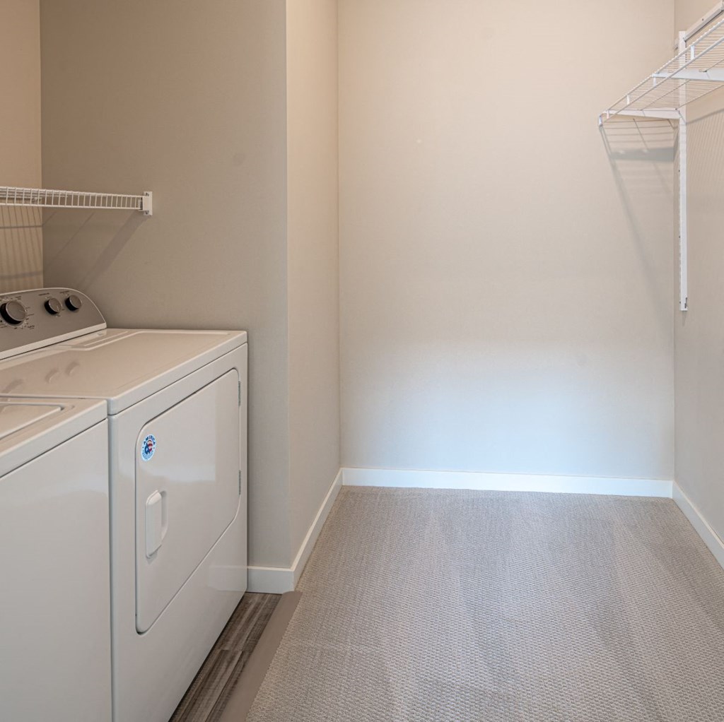 a washer and dryer in a laundry room with a white wall