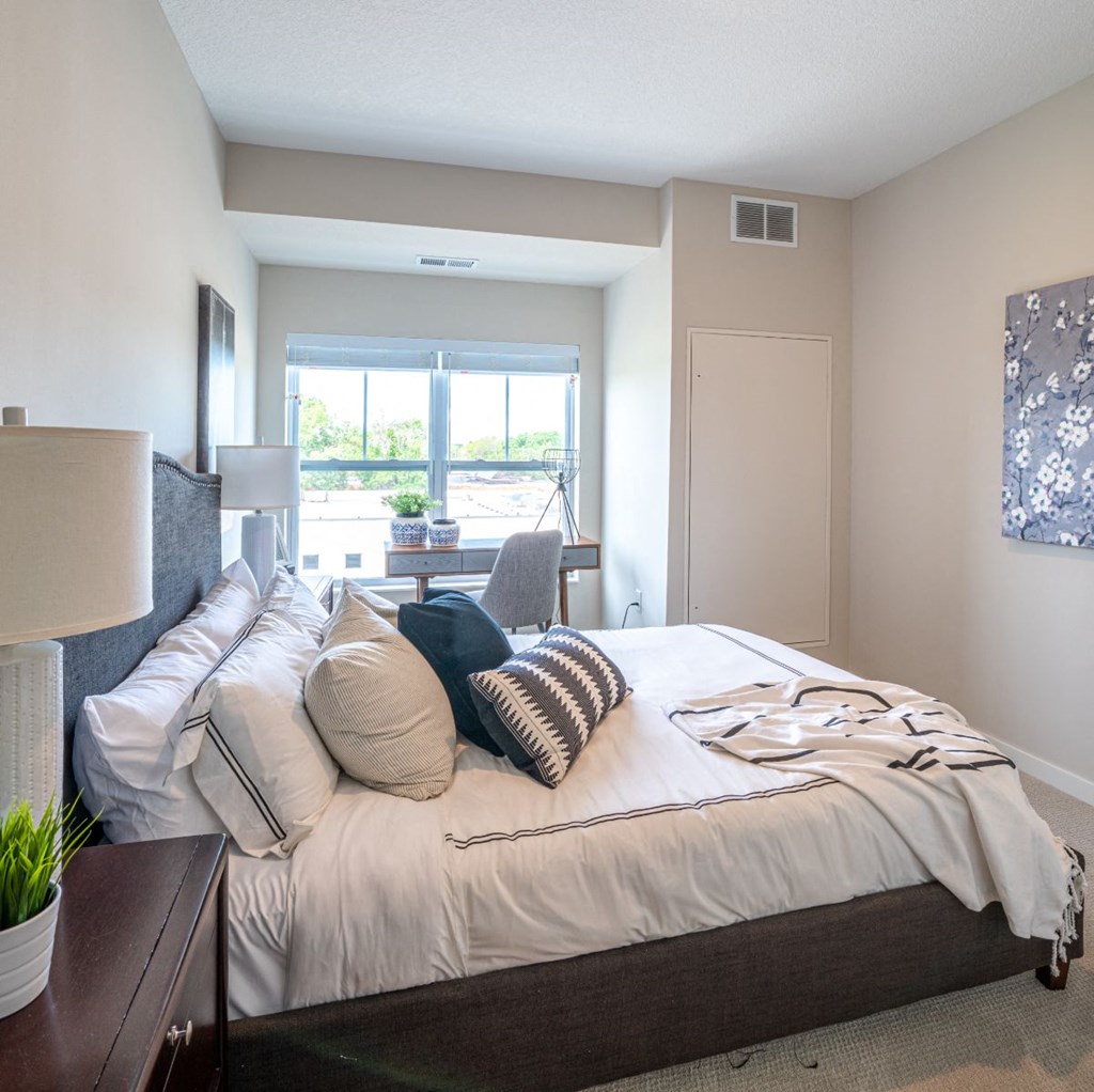 a bedroom with a large bed and a window