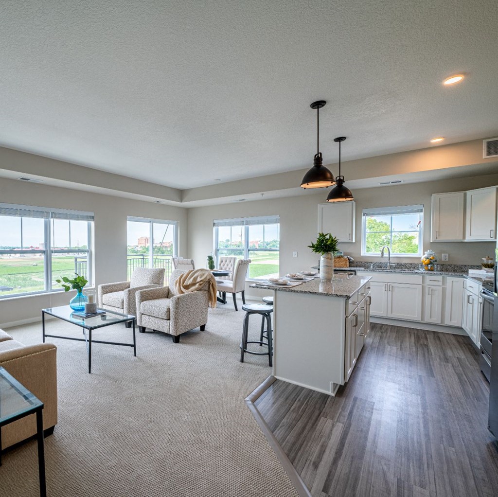 the gathering room and kitchen of a new home