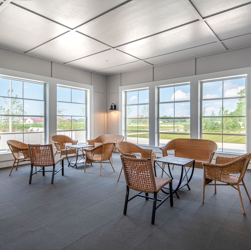 a dining room with tables and chairs and windows