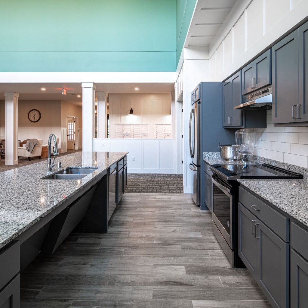 a kitchen with granite counter tops and black cabinets