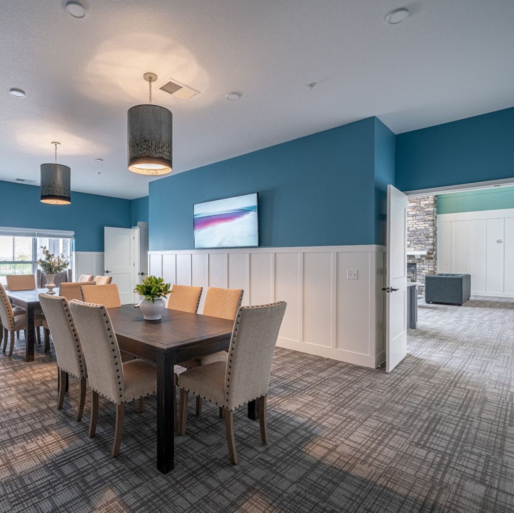 a dining room with a table and chairs and a tv