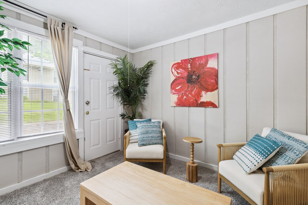 a living room with two chairs and a table