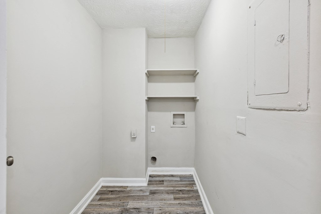 an empty room with white walls and a white closet and stairs
