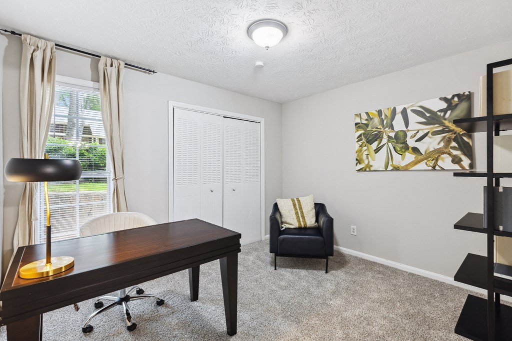 an office with a desk and a chair and a window