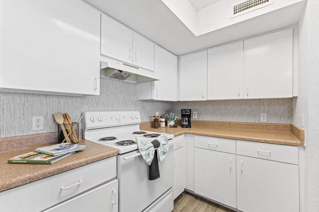 a white kitchen with white appliances and white cabinets