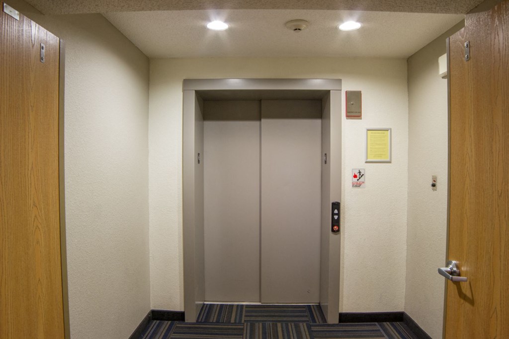 an elevator in a hallway with a door closed