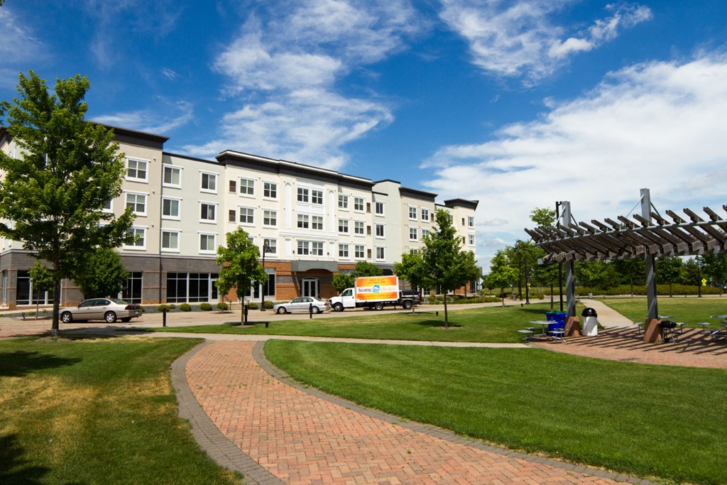 a large white building with a park in front of it