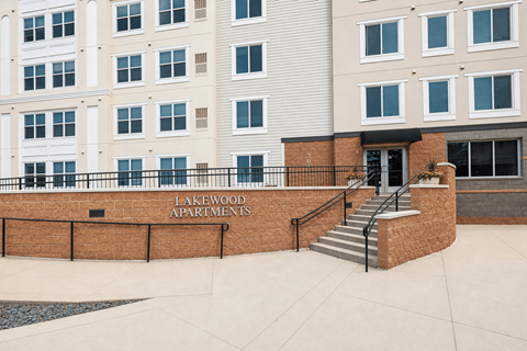 Property entrance sign with brick facade at Lakewood Apartments, Lino Lakes