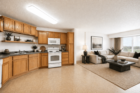 A modern kitchen with wooden cabinets and a white oven.