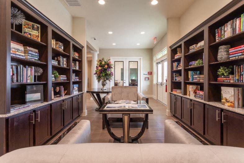 a library with a couch and a table