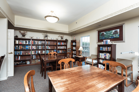 a dining room with tables and chairs and a library