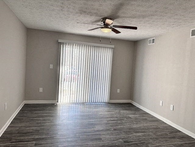 A room with a ceiling fan and a window with blinds.
