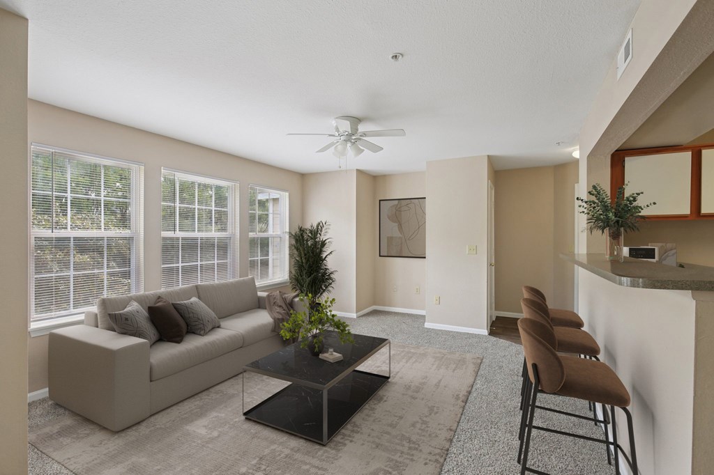 A living room with a couch, chairs, and a coffee table.