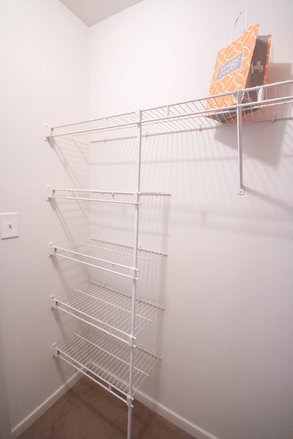 a wire closet shelf in a white room