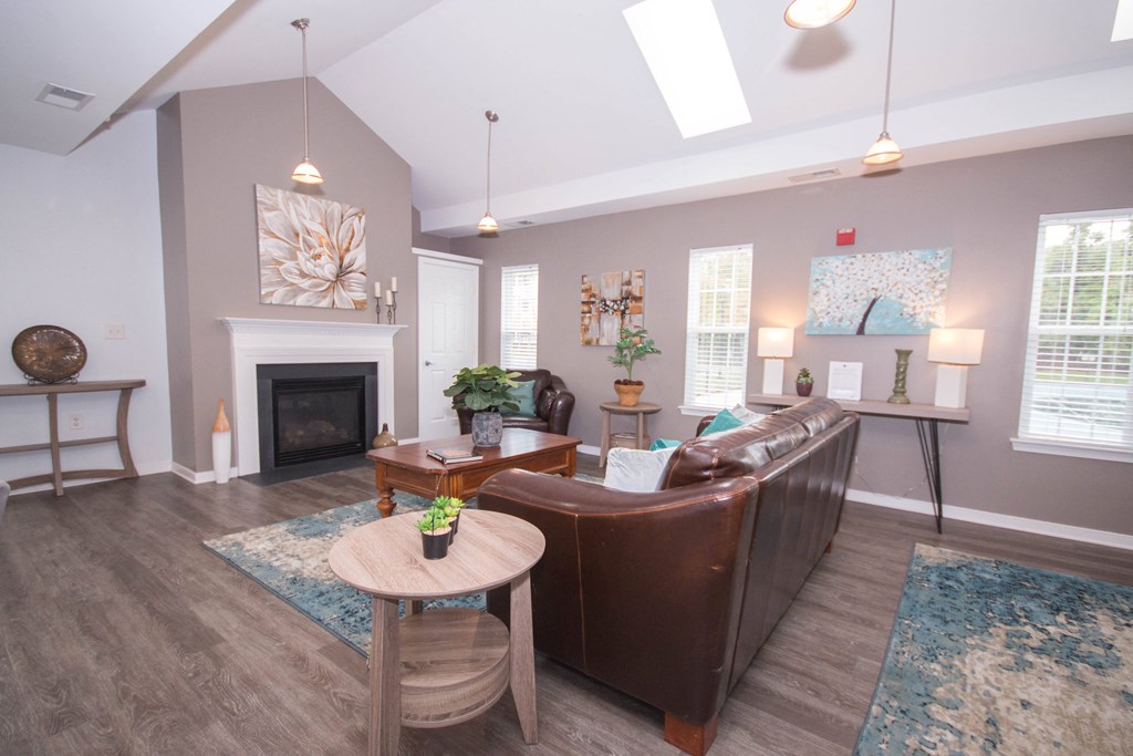 a living room with a leather couch and a fireplace