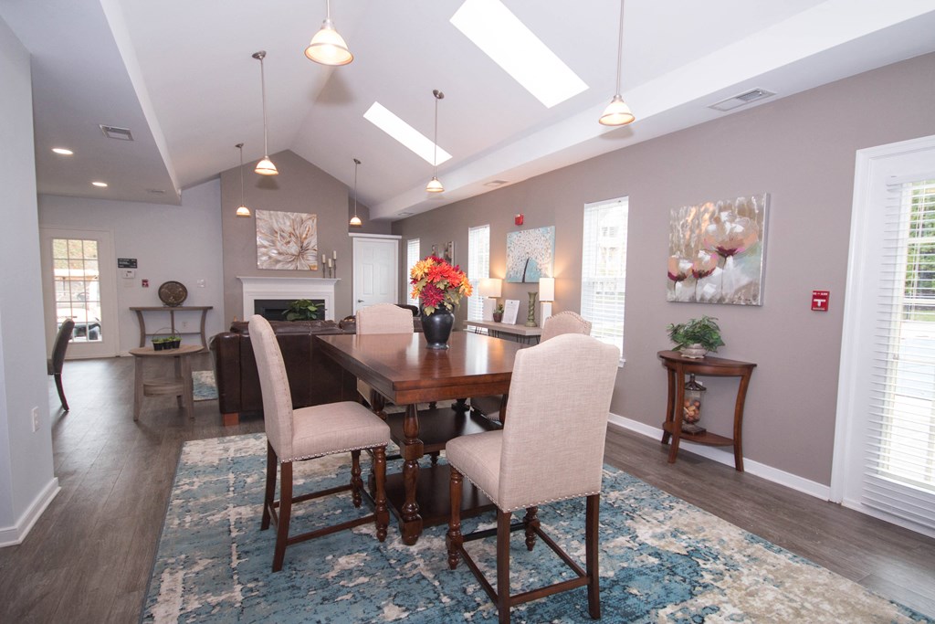 a dining room and living room with a table and chairs