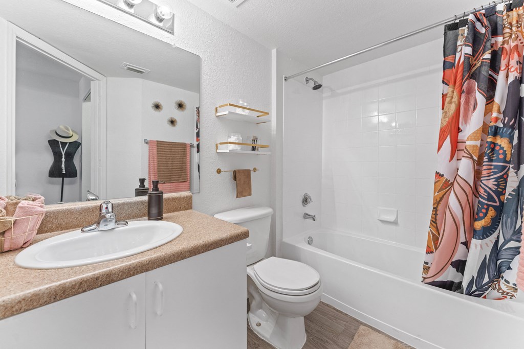 a bathroom with a shower and a sink and a toilet