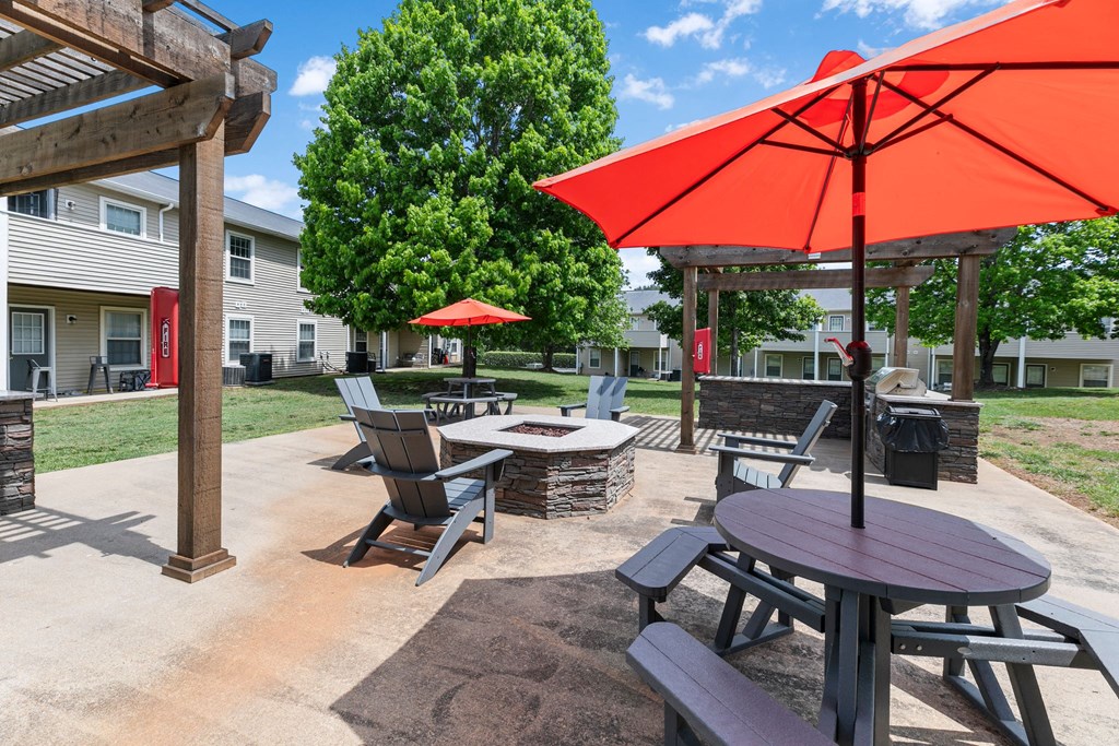 a patio with tables and chairs and umbrellas