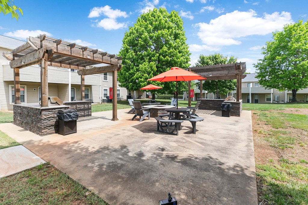 our apartments have a patio with picnic tables and umbrellas