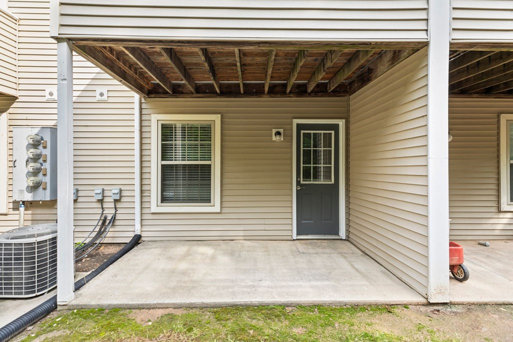 the front of a house with a porch and a door