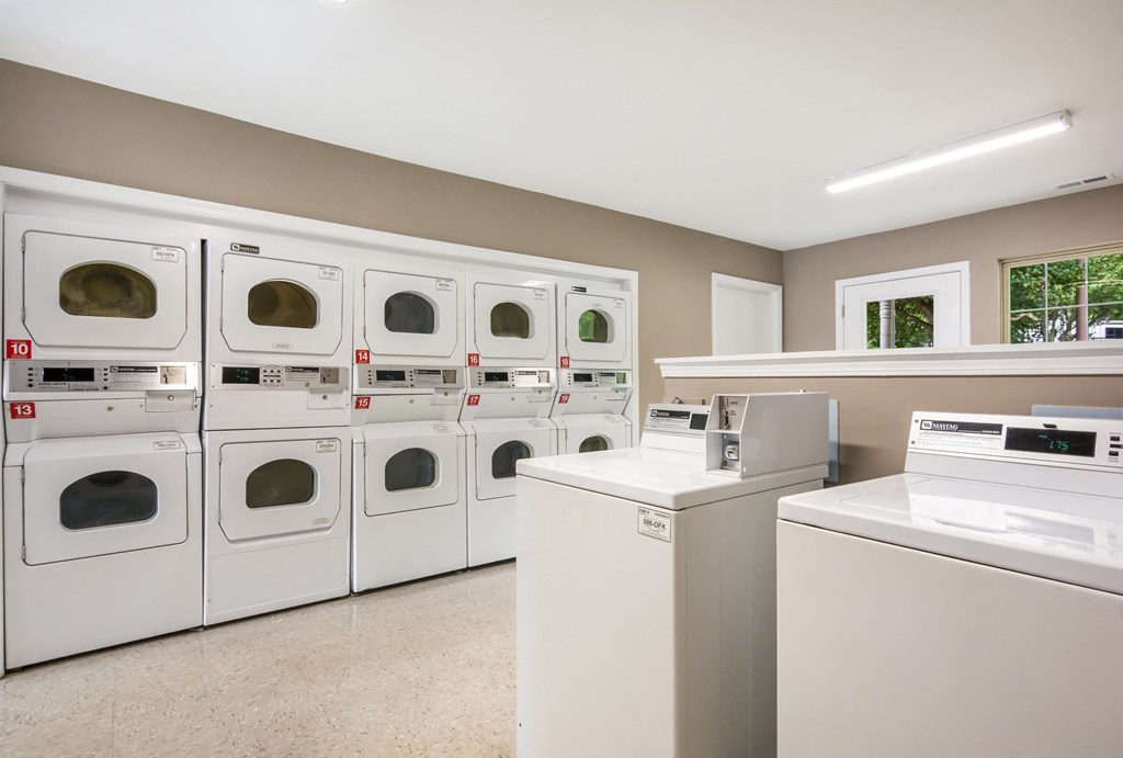 A row of washing machines in a laundromat.