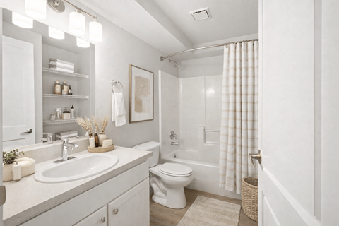 Modern bathroom with white vanity and tub at Fort Lane Apartments, Layton