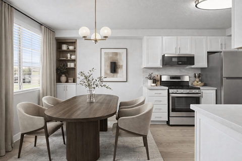 A modern kitchen with a dining table and chairs.
