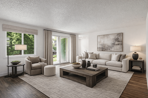 A living room with a grey sofa, a wooden coffee table, and a large painting on the wall.