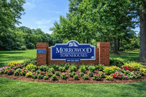 A sign for Morrowood Townhouses with a phone number on it.