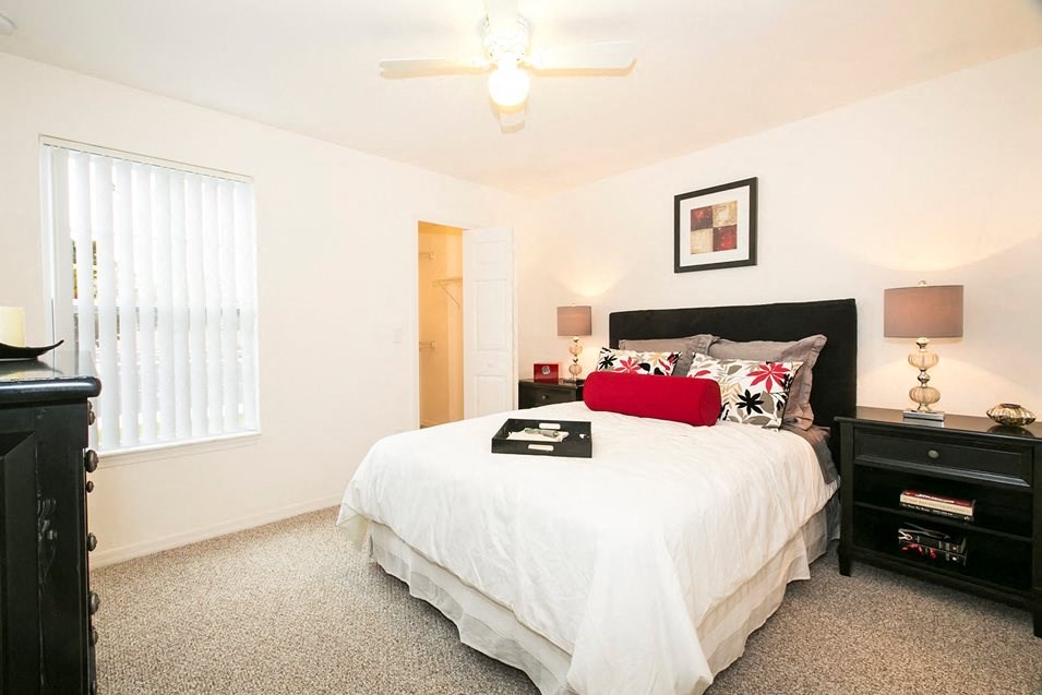 a bedroom with a bed and a window