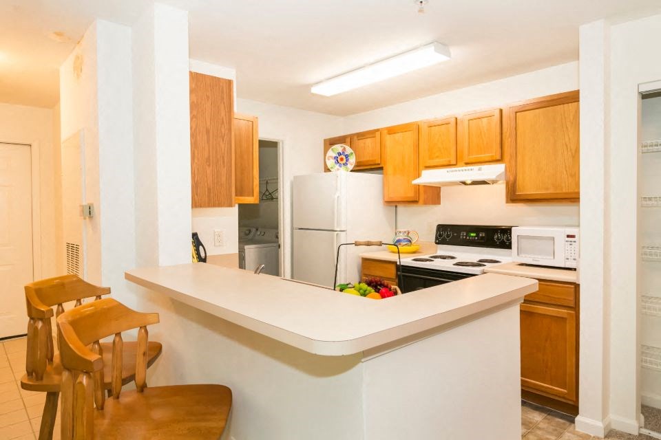 a kitchen with a counter top and a refrigerator