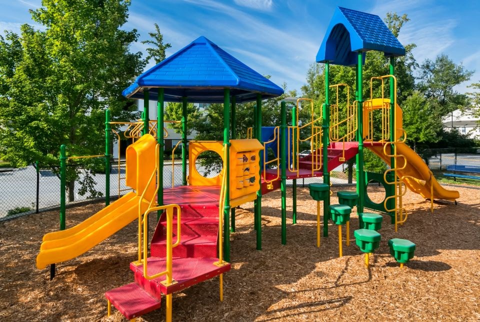 a colorful playground with slides and other toys in a park