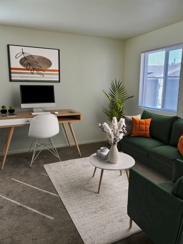 A modern living room with a green couch, a white desk, and a painting on the wall.