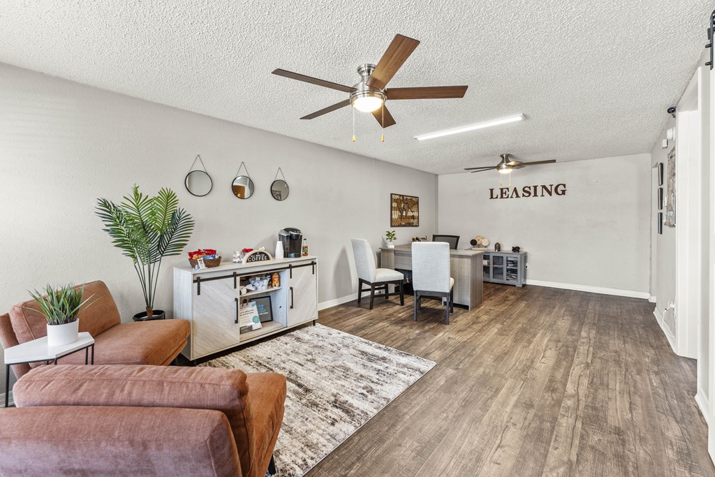 the living room and dining area of a house with a ceiling fan