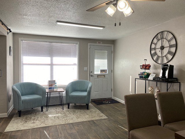 a living room with two chairs and a clock on the wall