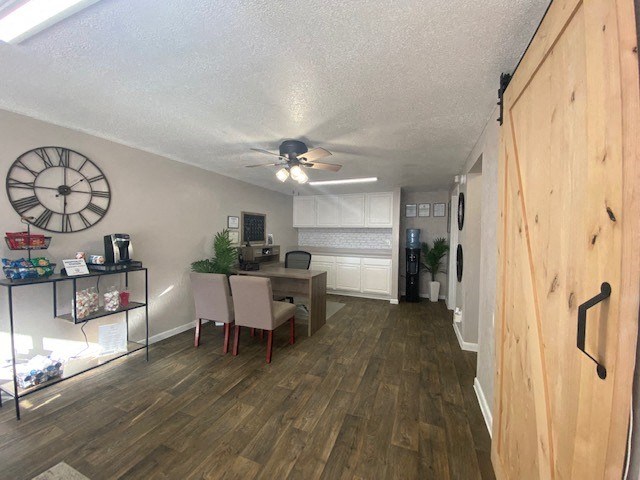 a living room and dining room with a clock on the wall
