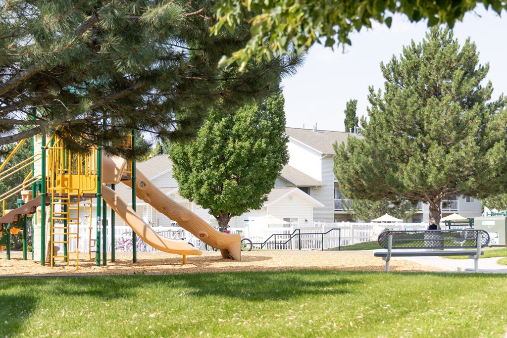 a playground with a slide in a park