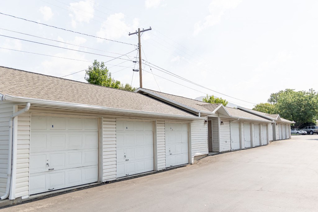 a row of white garages with white garage doors