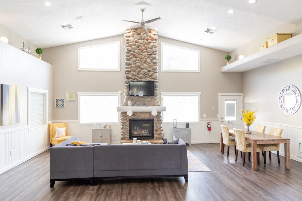 a living room with a fireplace and a table with chairs
