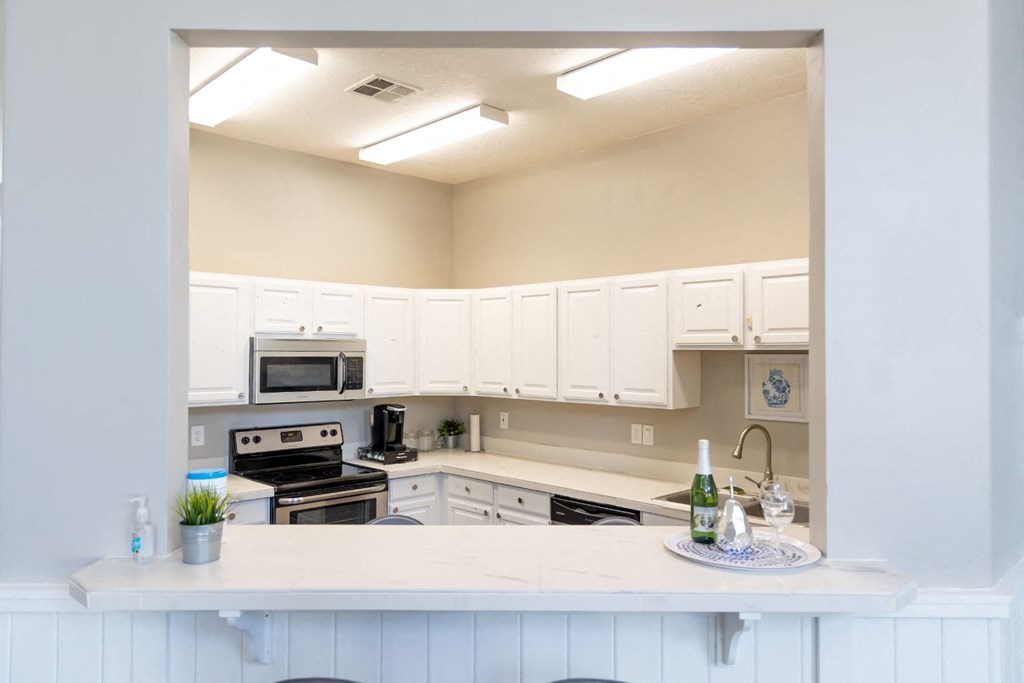 a kitchen with white cabinets and a counter top